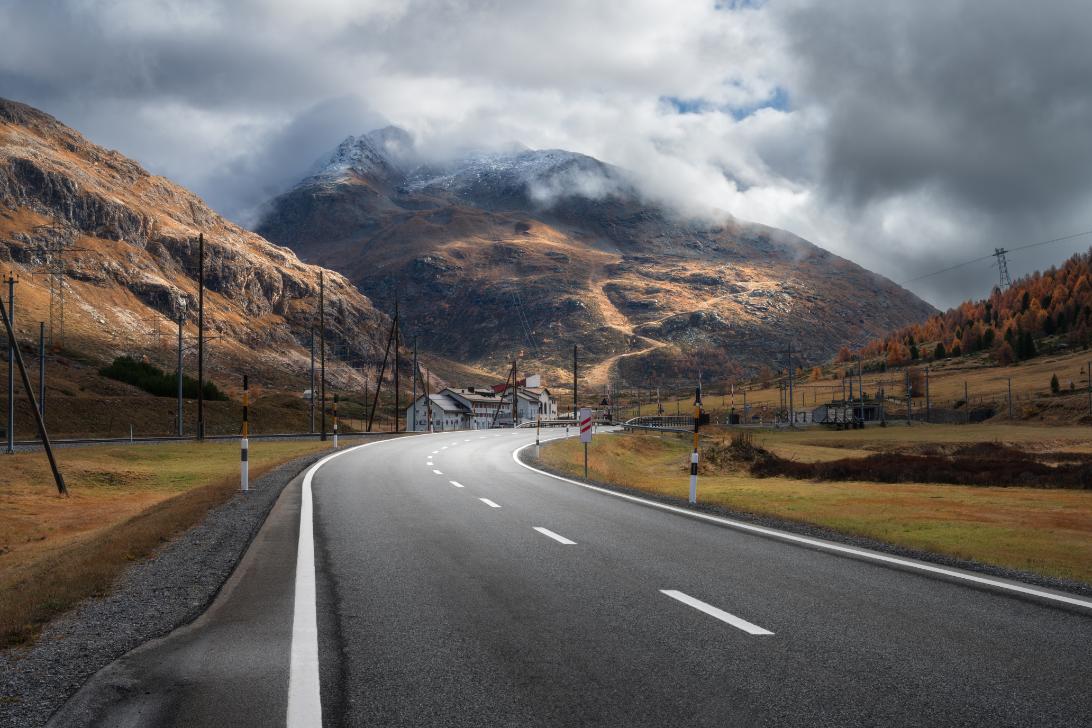 Scenic countryside road through green rolling hills in Europe