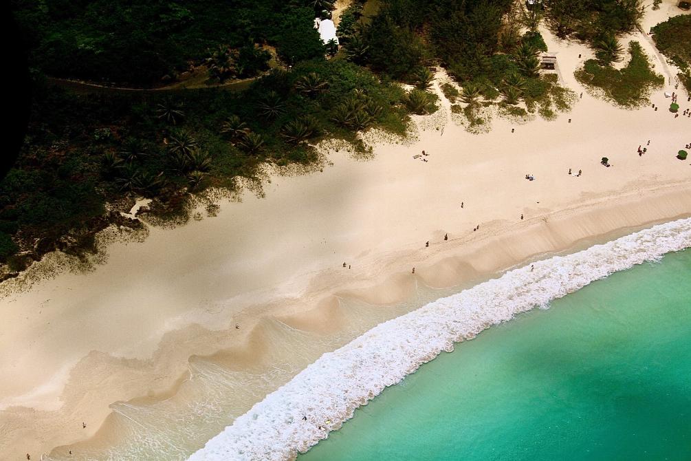 aerial view of stunning white sand beach and blue ocean