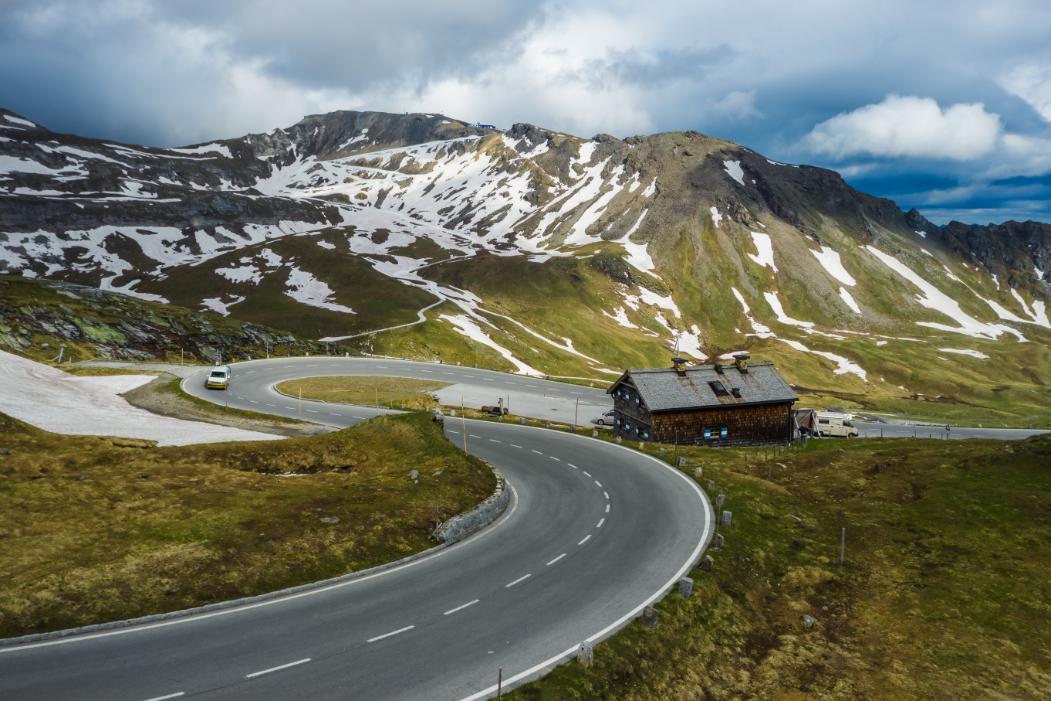 Snow-capped mountains and winding road through the Swiss Alps